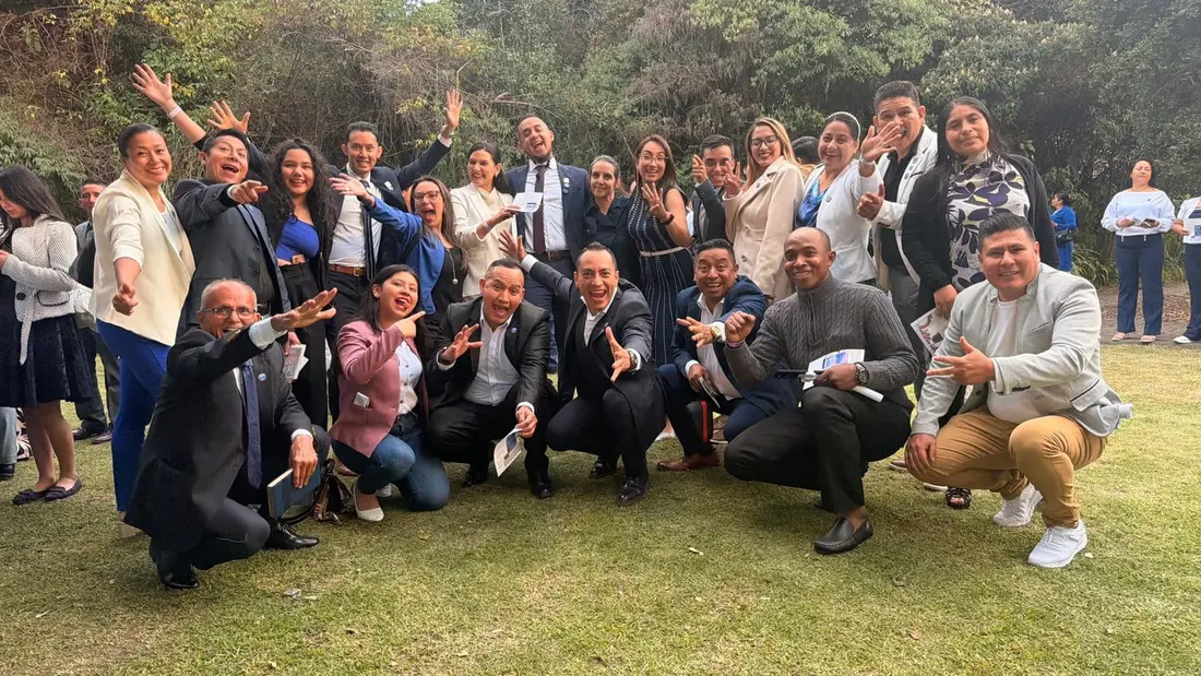Equipo de líderes celebrando juntos al aire libre sobre el césped